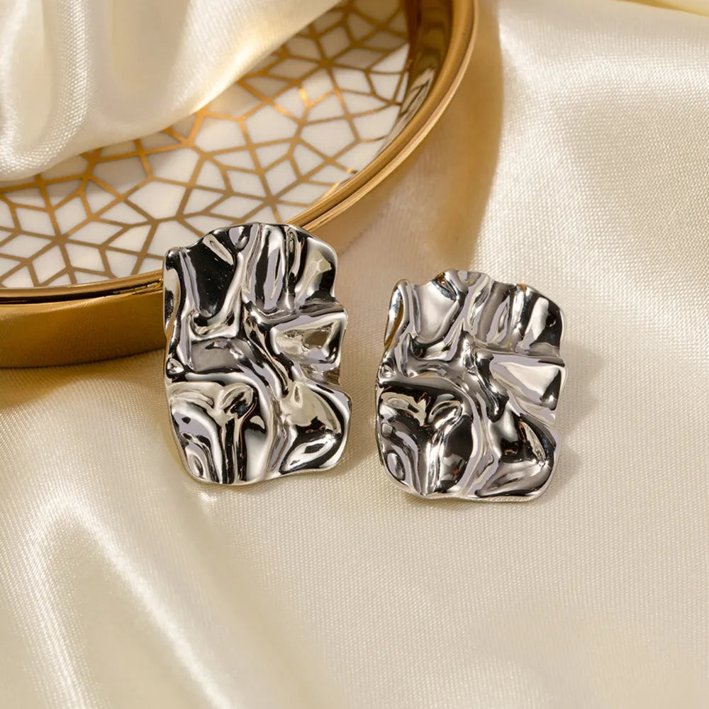 Side view of silver geometric square studs