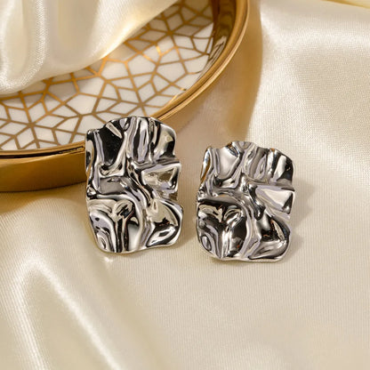 Side view of silver geometric square studs